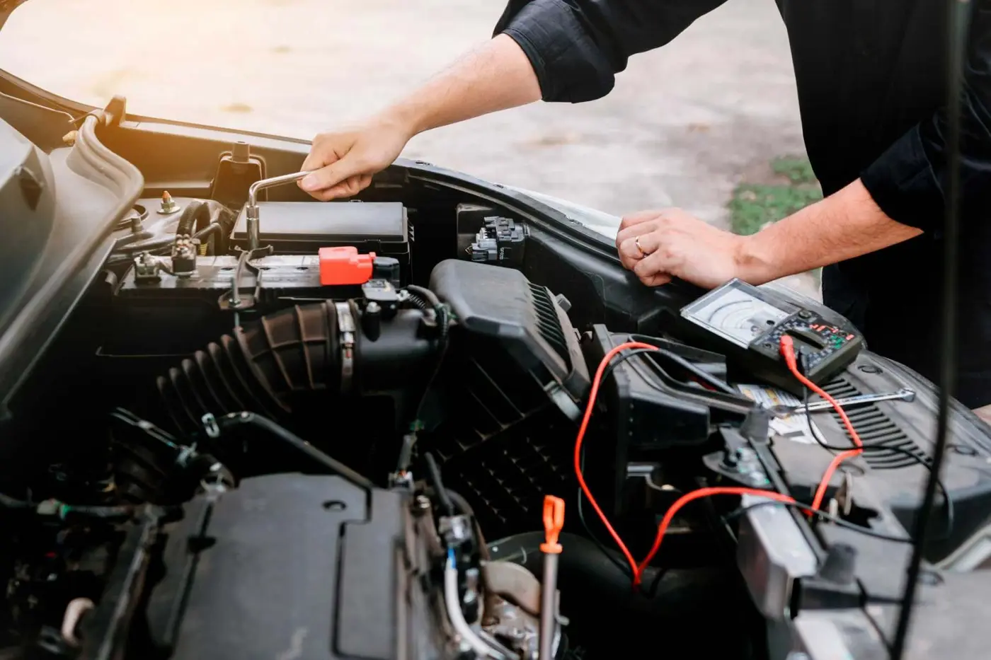 Mechanic running a diagnostic check under the bonnet on a car air conditioning system at C.A.M.S. Chippenham
