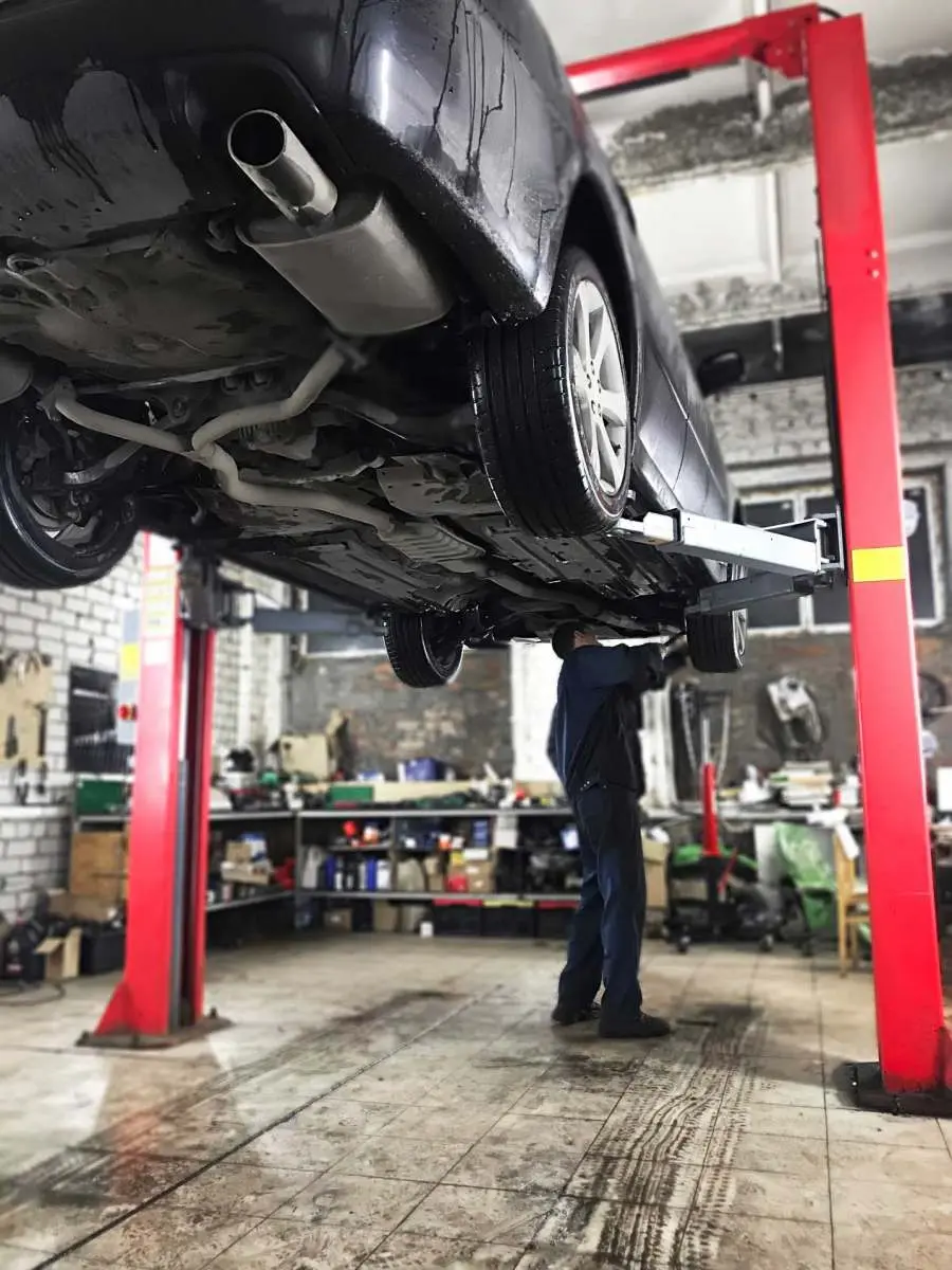 Vehicle undergoing an MOT test and safety inspection at C.A.M.S. garage Chippenham