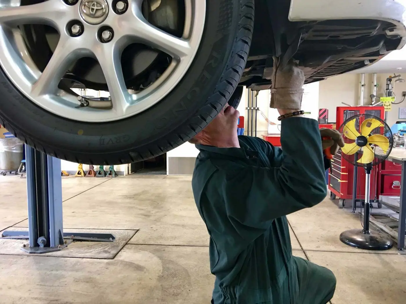 Car raised on a ramp for a free inspection at C.A.M.S. garage Chippenham