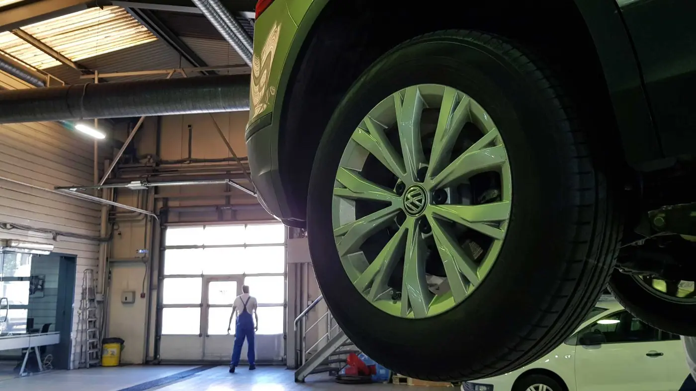 Vehicles on hydraulic lifts in the MOT testing bay at C.A.M.S. Chippenham