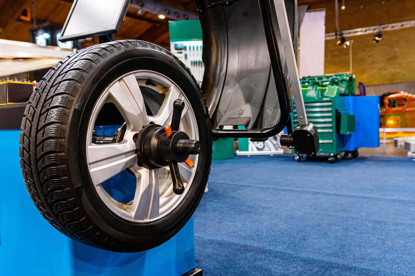 Car wheel on an automated wheel balancing machine at C.A.M.S. garage Chippenham